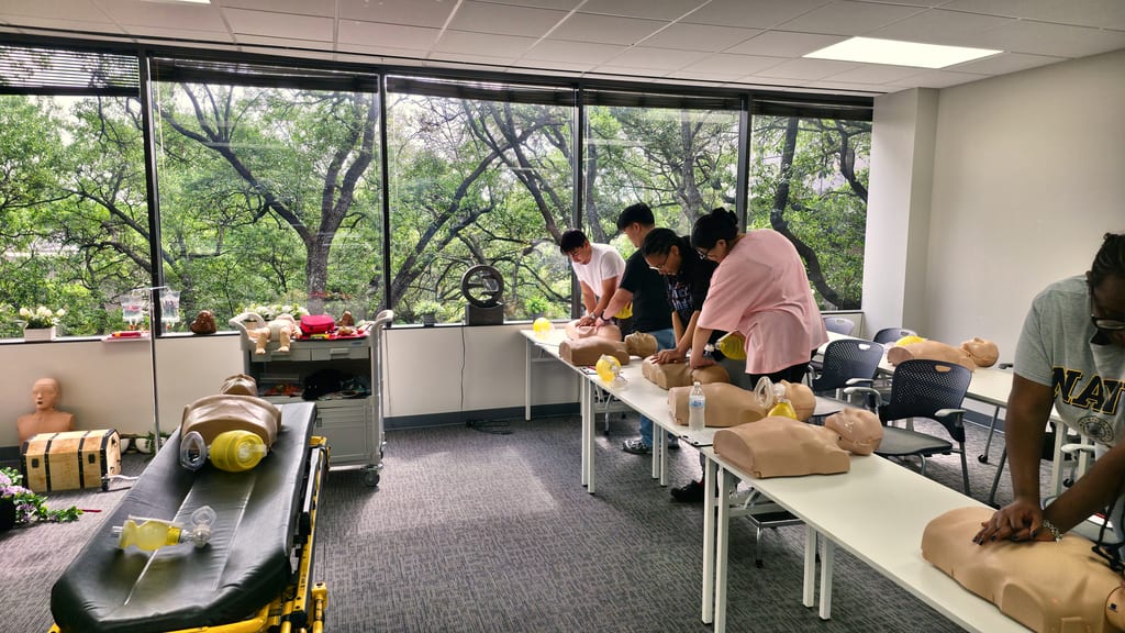 Students practicing CPR skills during a Cardiox Care class in Houston.
