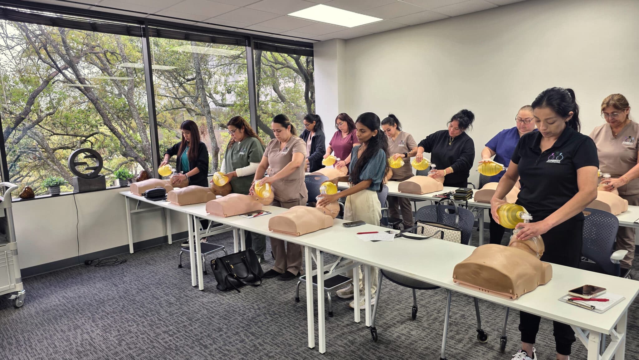 Students practicing adult bag-mask ventilations with BVM devices during hands-on BLS training
